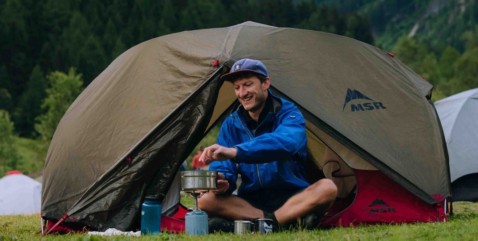Hiker taking a break near their tent on the MTB.